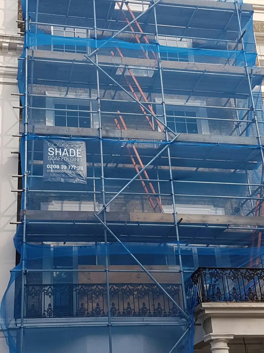 Blue debris netting and a Shade Scaffolding banner
